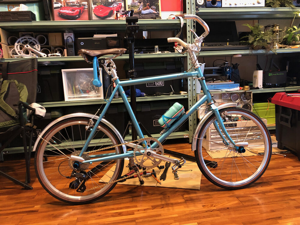 同じ自転車を少し斜めから。工具棚と木の床が写る